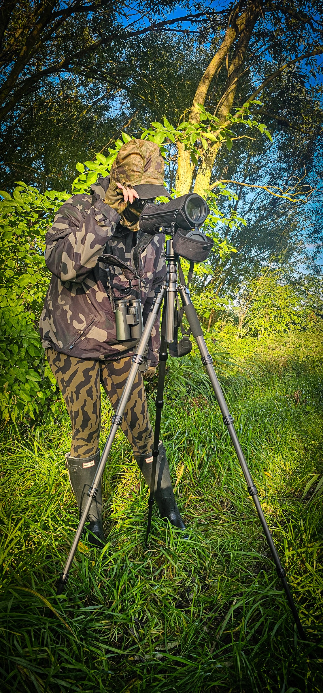 Watching through a spotting scope on a tripod, with binoculars ready to hand