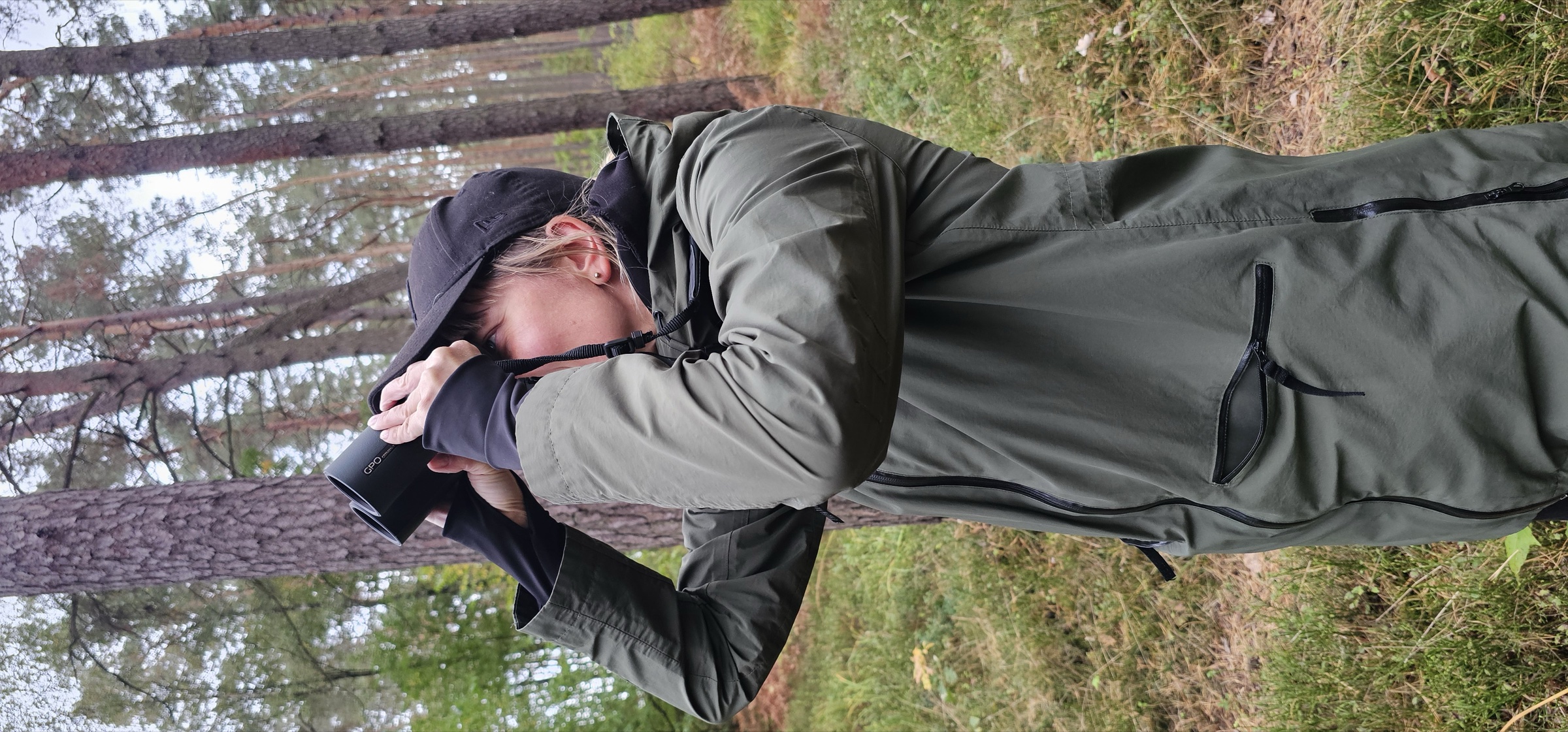 Watching through GPO binoculars during a walk in a pine forest